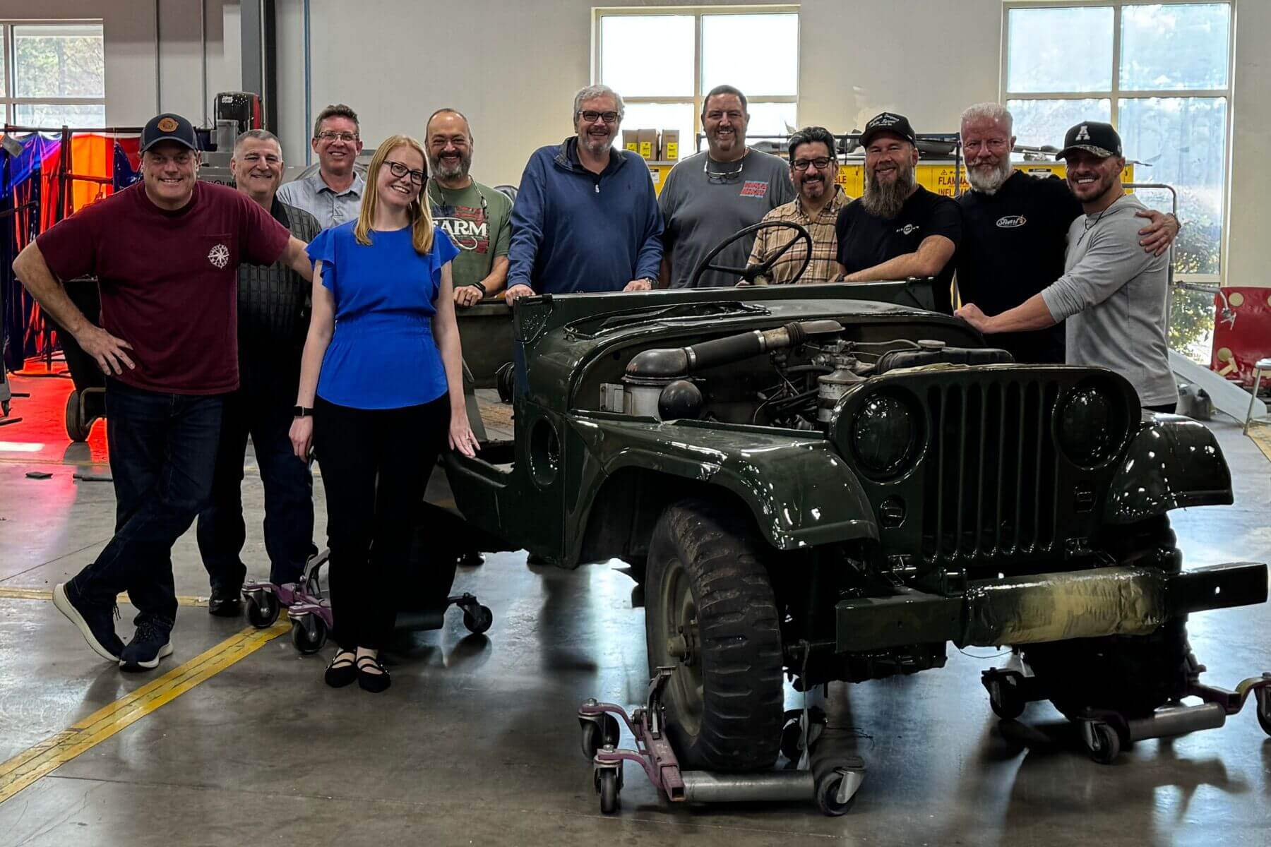 group photo in front of vehicle