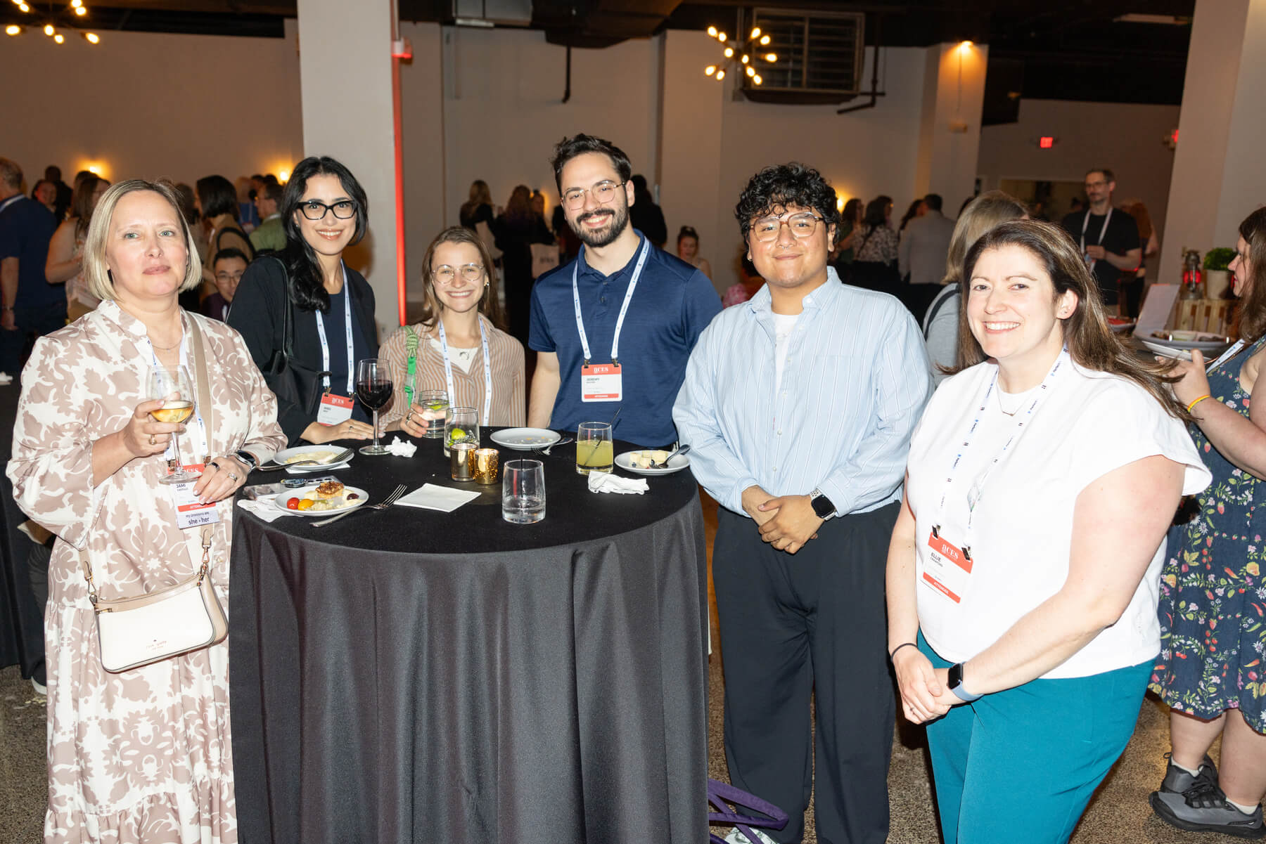 group of people standing around table