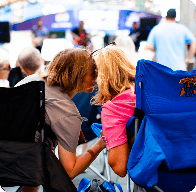 Man whispering in woman's ear