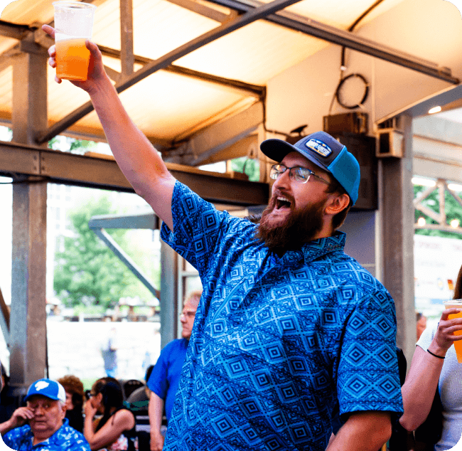 man raising a glass and cheering