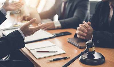 people negotiating, gavel on desk