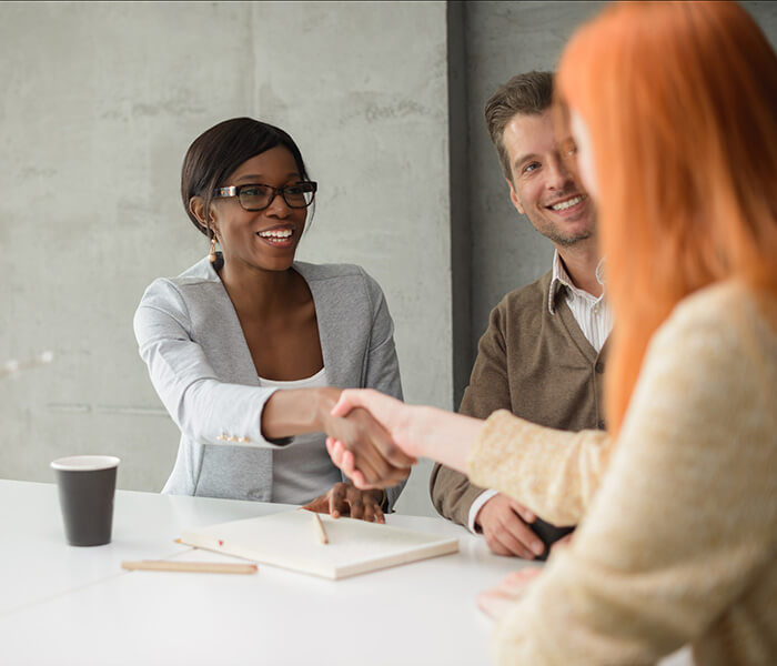 Shot of a young couple meeting with their financial advisor.