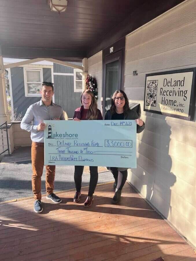 DeLand Receiving Home with a $3,000 check