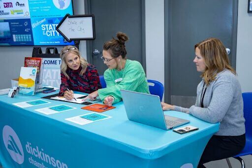 3 women at the Dickson Area Chamber of Commerce table talking