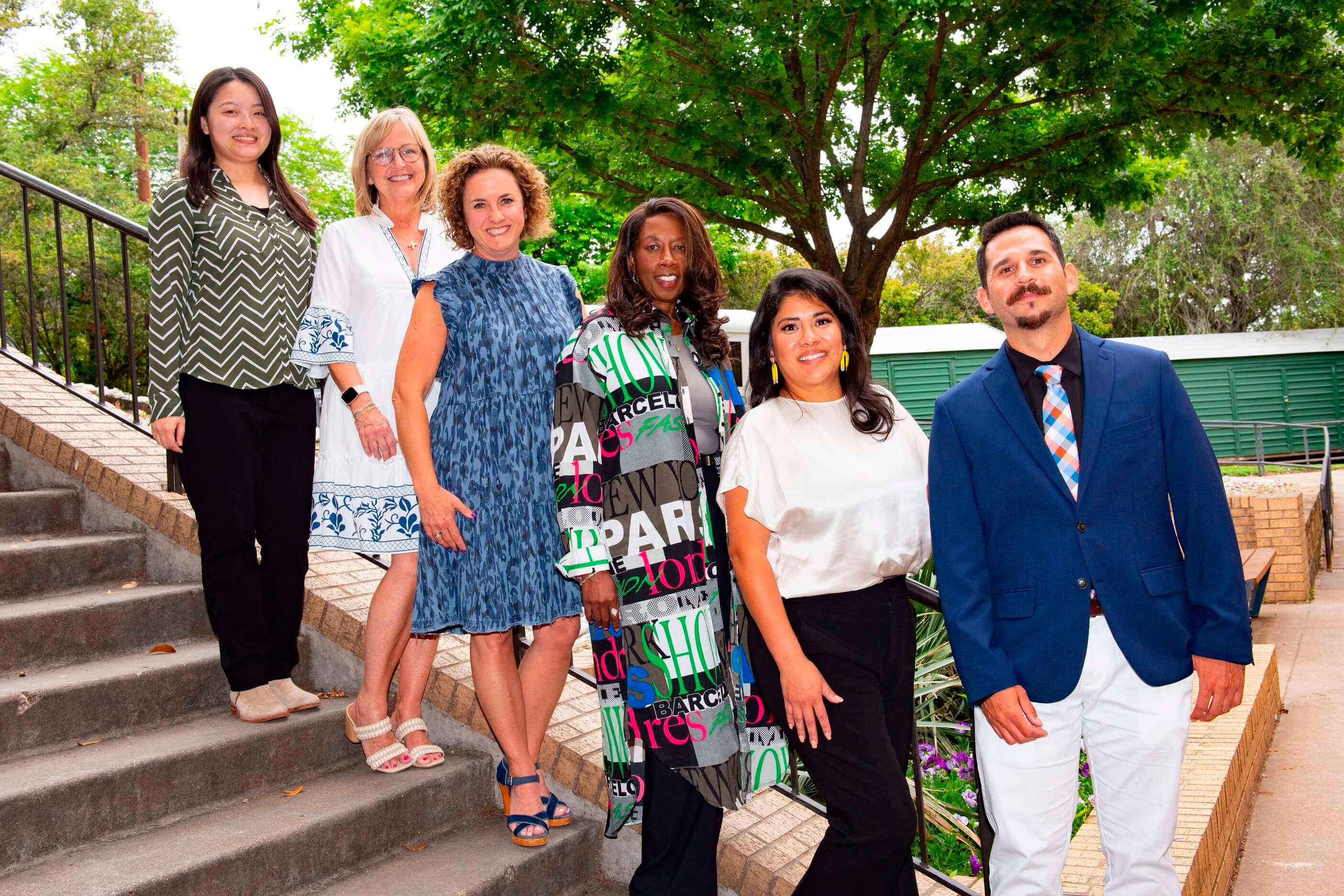 professionals lined up on stairs for photo outside