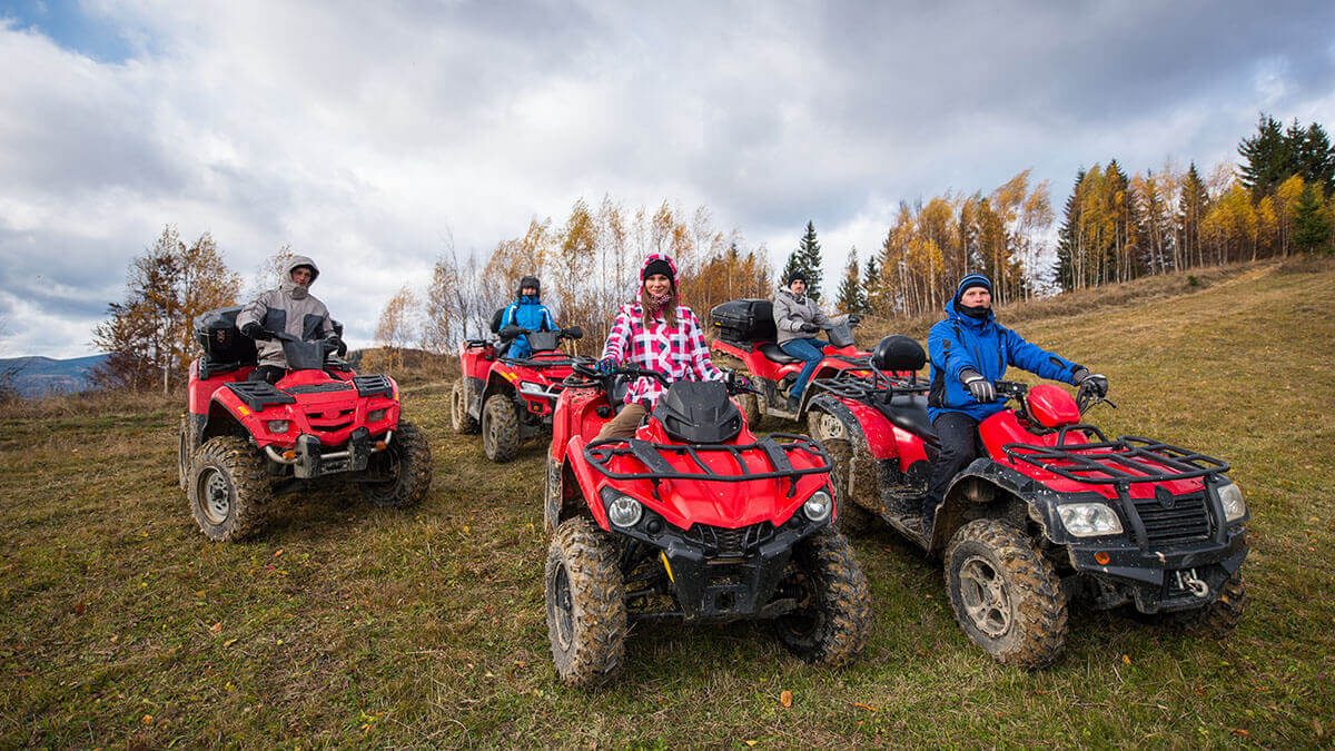 group of 5 atvs getting ready to ride in the mountains