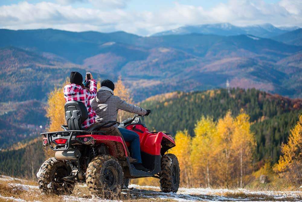 couple riding ATV in the mountains