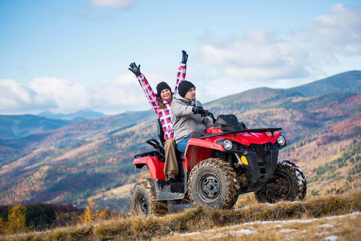 couple riding ATV in the mountains