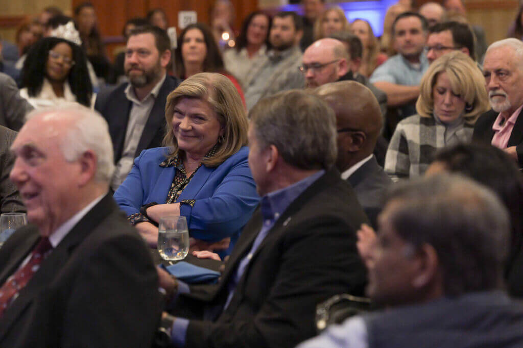 attendees smile at the Annual Dinner