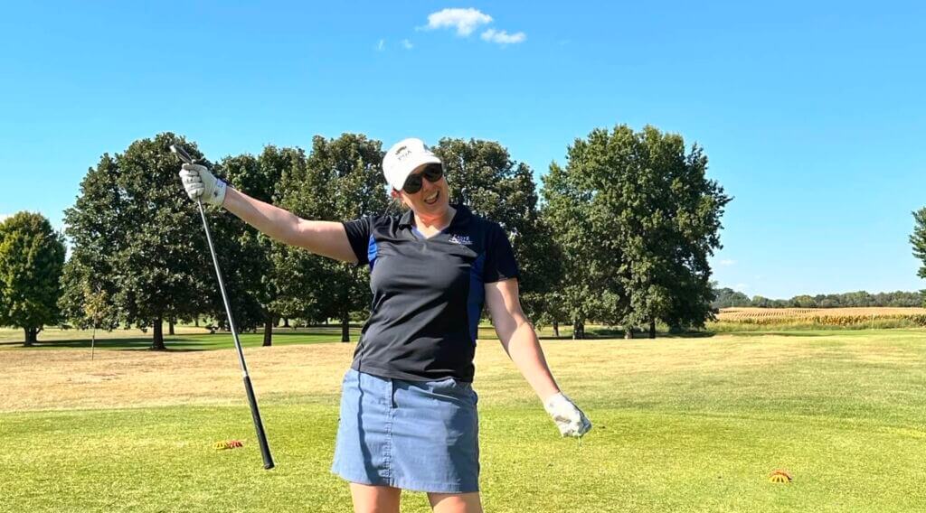 A golfer follows through on a tee shot on a sunny day at the Golf Classic