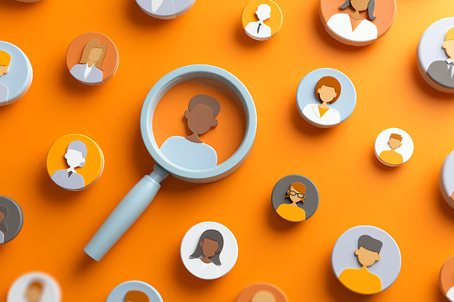 Diverse group of people icons under magnifying glass on an orange background