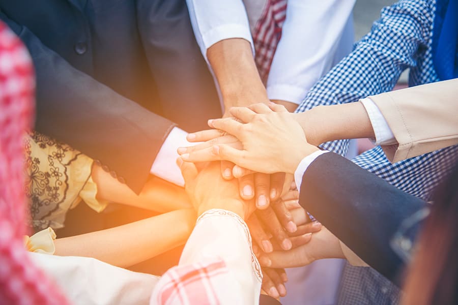 Diverse multiethnic Partners hands together teamwork group of multi racial people meeting join hands togetherness. Diversity people hands join empower partnership teams connection volunteer community