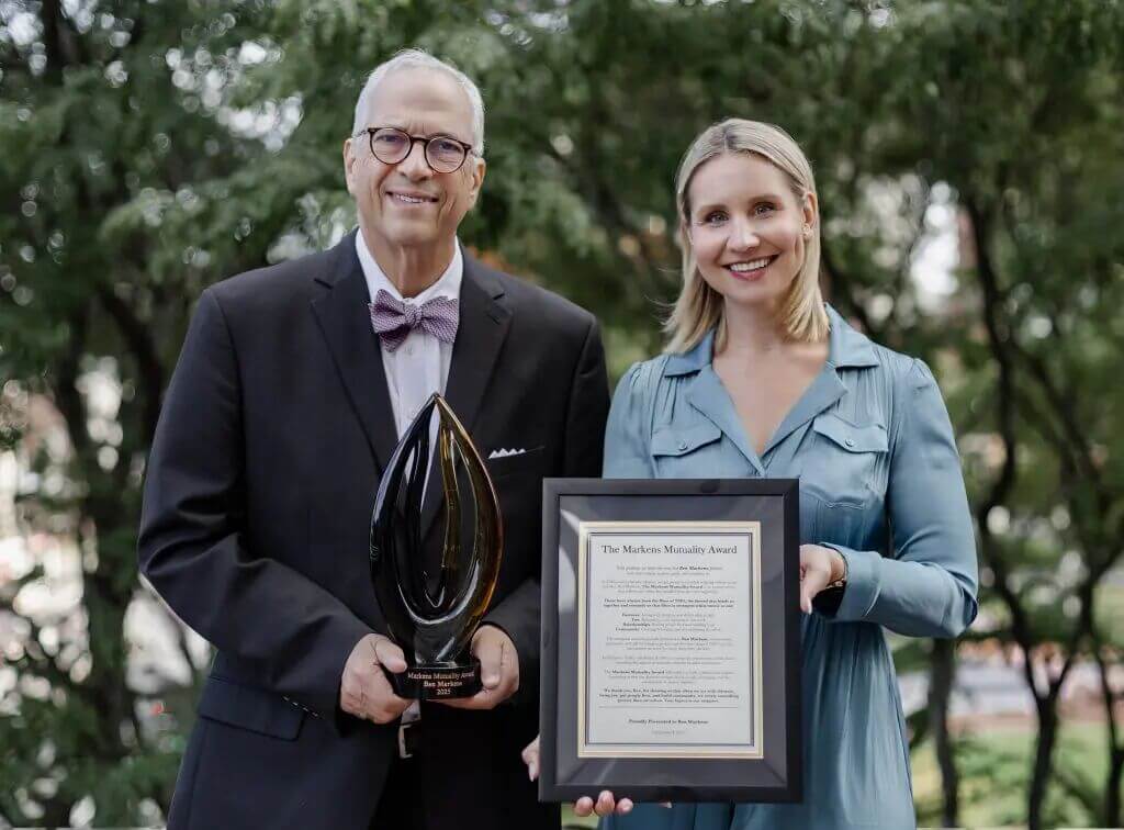 Emily Leonczyk, President &amp; CEO of The Markens Group, presents Founder Ben Markens with the inaugural Markens Mutuality Award. In honor of the occasion, a donation will be made to a nonprofit of choice.