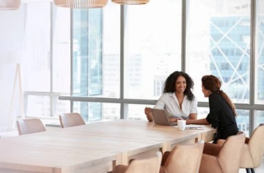 business professionals talking around a table