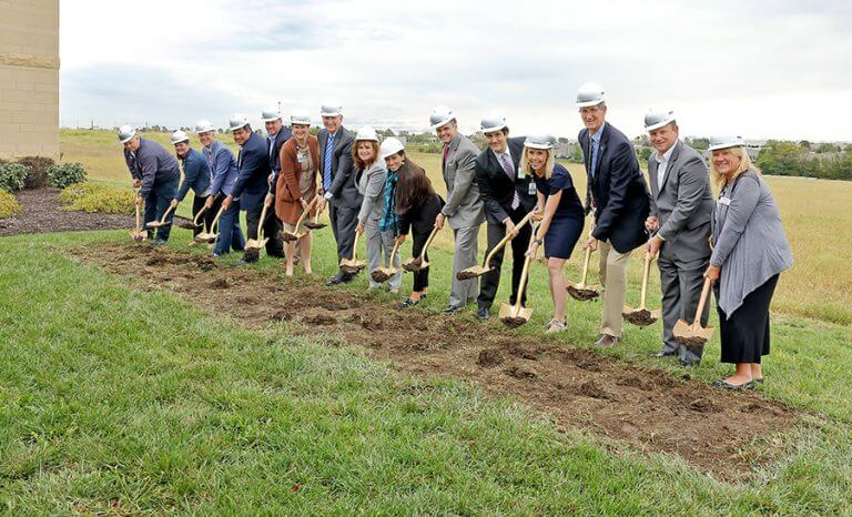 AH-SouthOP-195es-768x466 Large group gathered at an outdoor groundbreaking ceremony in an open field