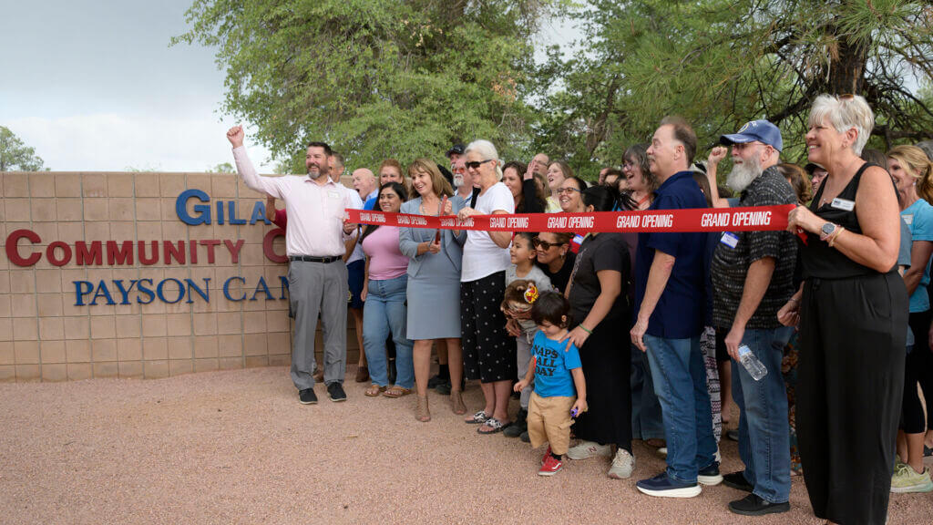 Group of people at a ribbon cutting ceremony outdoors