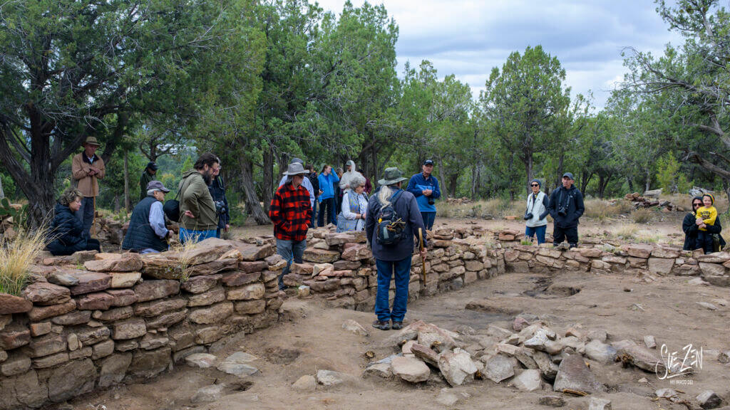 Families exploring ancient stone ruins along a creek