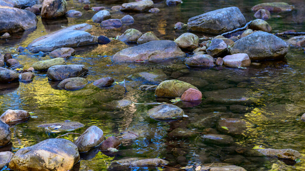 Close-up of smooth colorful river rocks