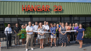 Ribbon cutting outside Hangar 28