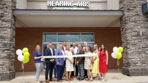 Ribbon cutting outside the Hear Again America hearing aids office