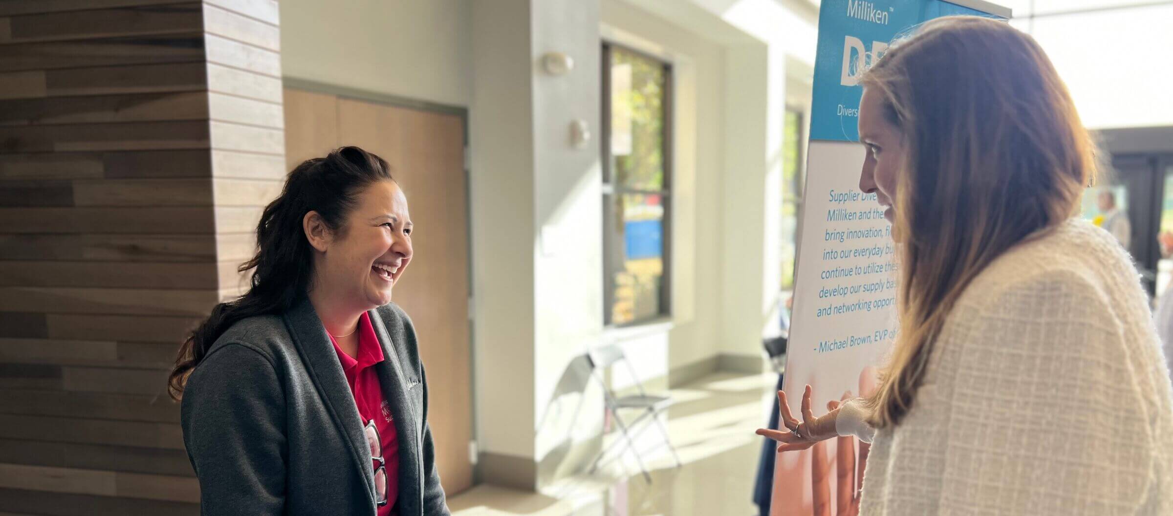 Attendees talking in a hallway at an event