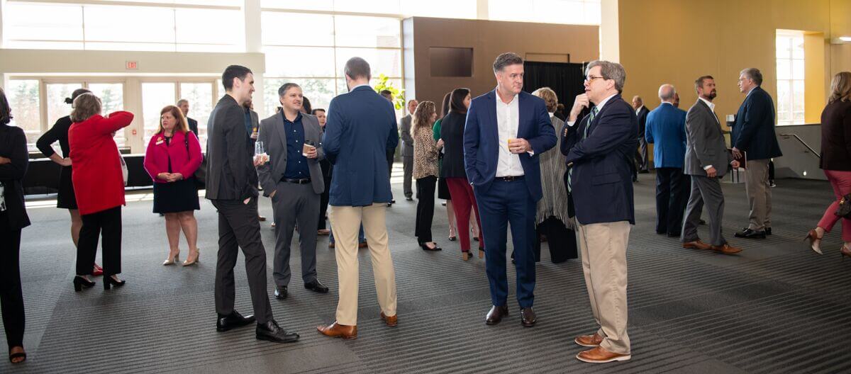 Attendees mingling at a networking event in an open office space