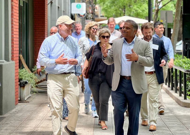 Greenville delegation walking a city sidewalk during a visit to Richmond