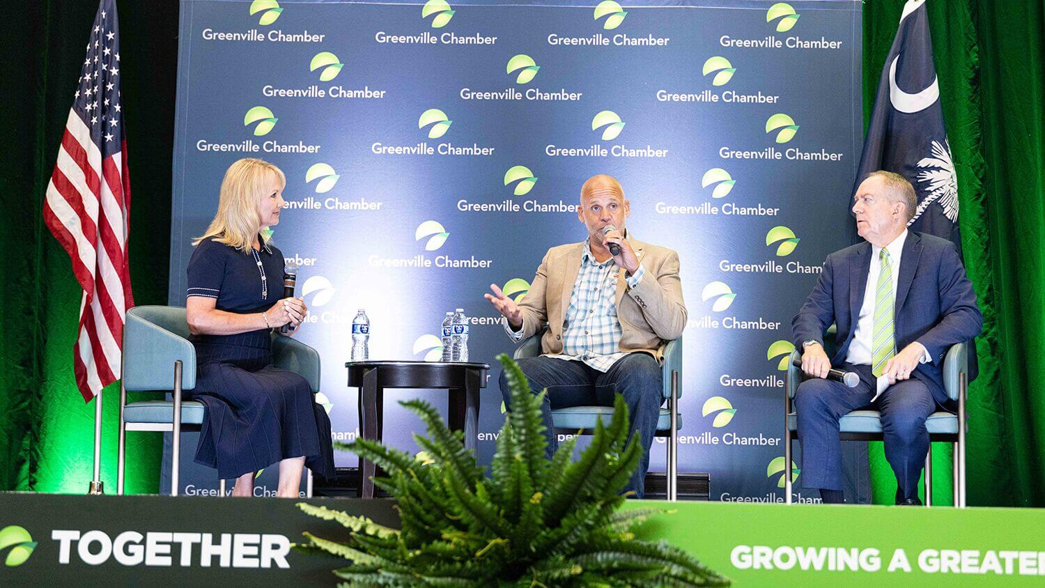 Panel discussion on stage in front of a Greenville Chamber backdrop at the 2026 State of Greenville
