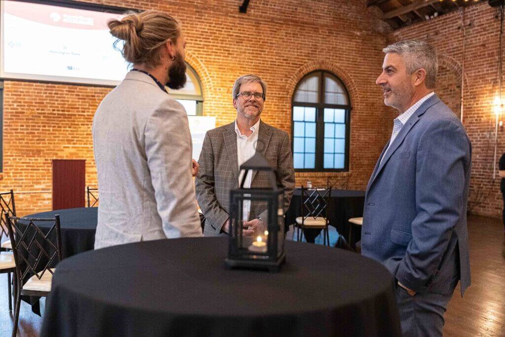 Accelerate shareholders talking around a cocktail table