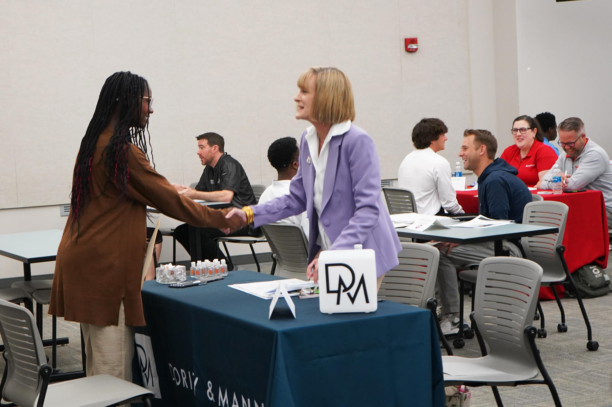 Attendees shaking hands at a networking event