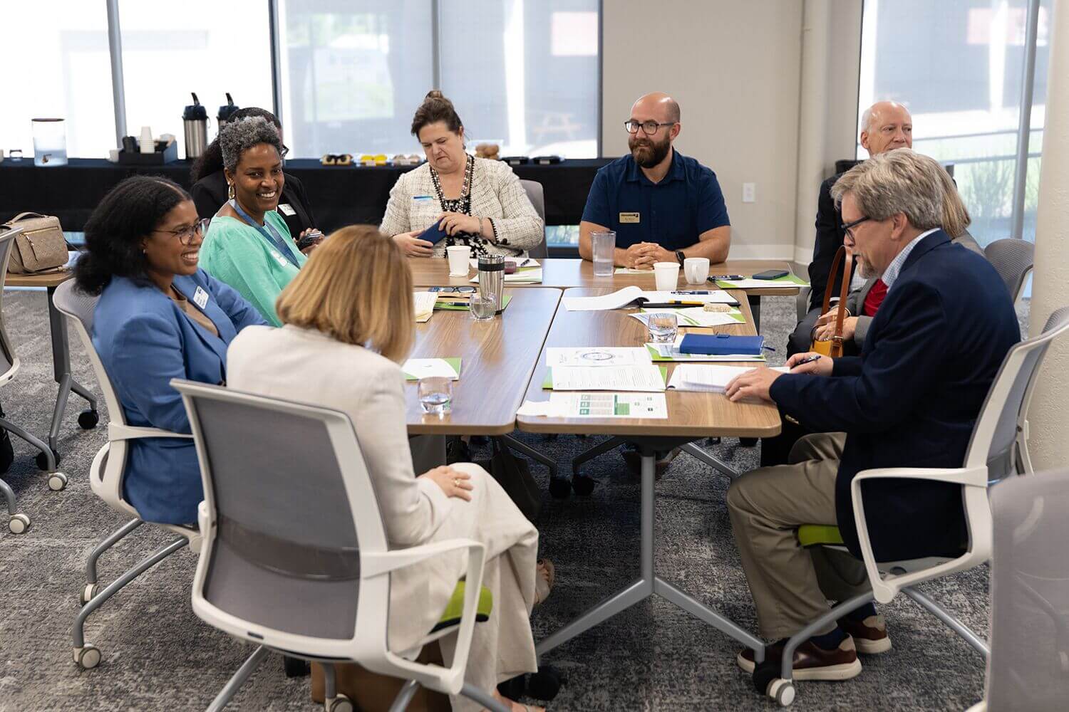 Attendees in discussion around a conference table