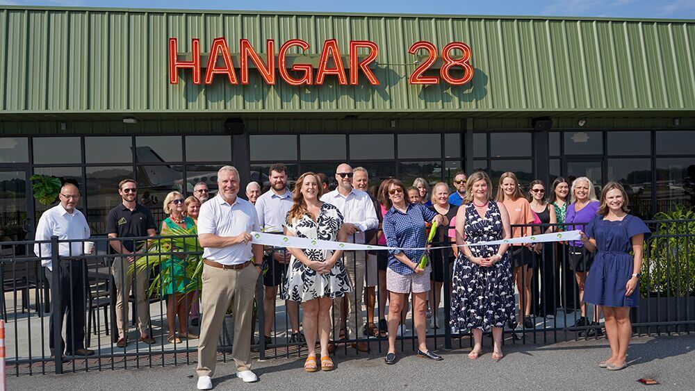 Ribbon cutting outside Hangar 28
