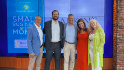 Larkins honored as Small Business of the Month, posing on stage