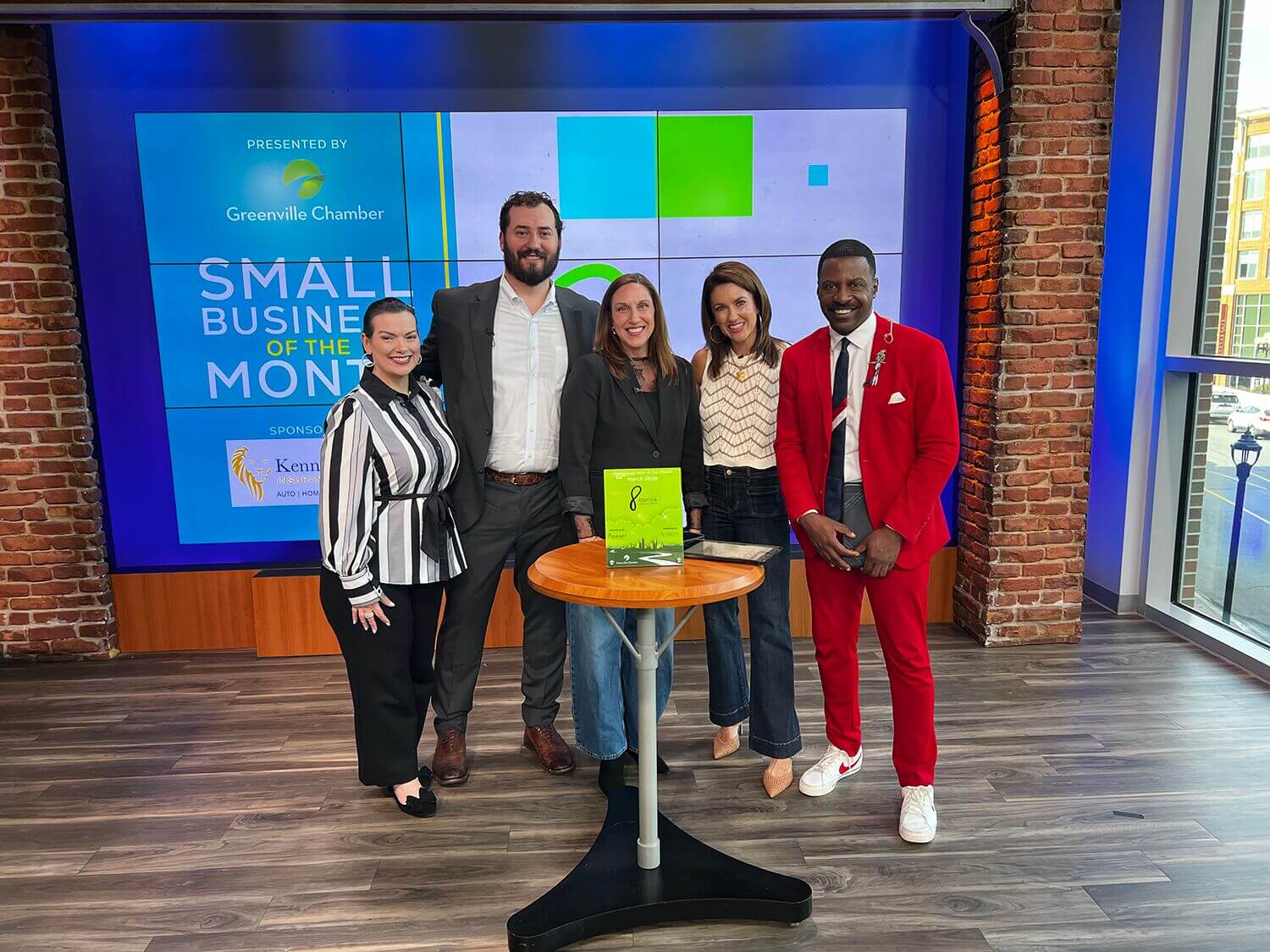 Small Business of the Month honorees posing on a TV studio set