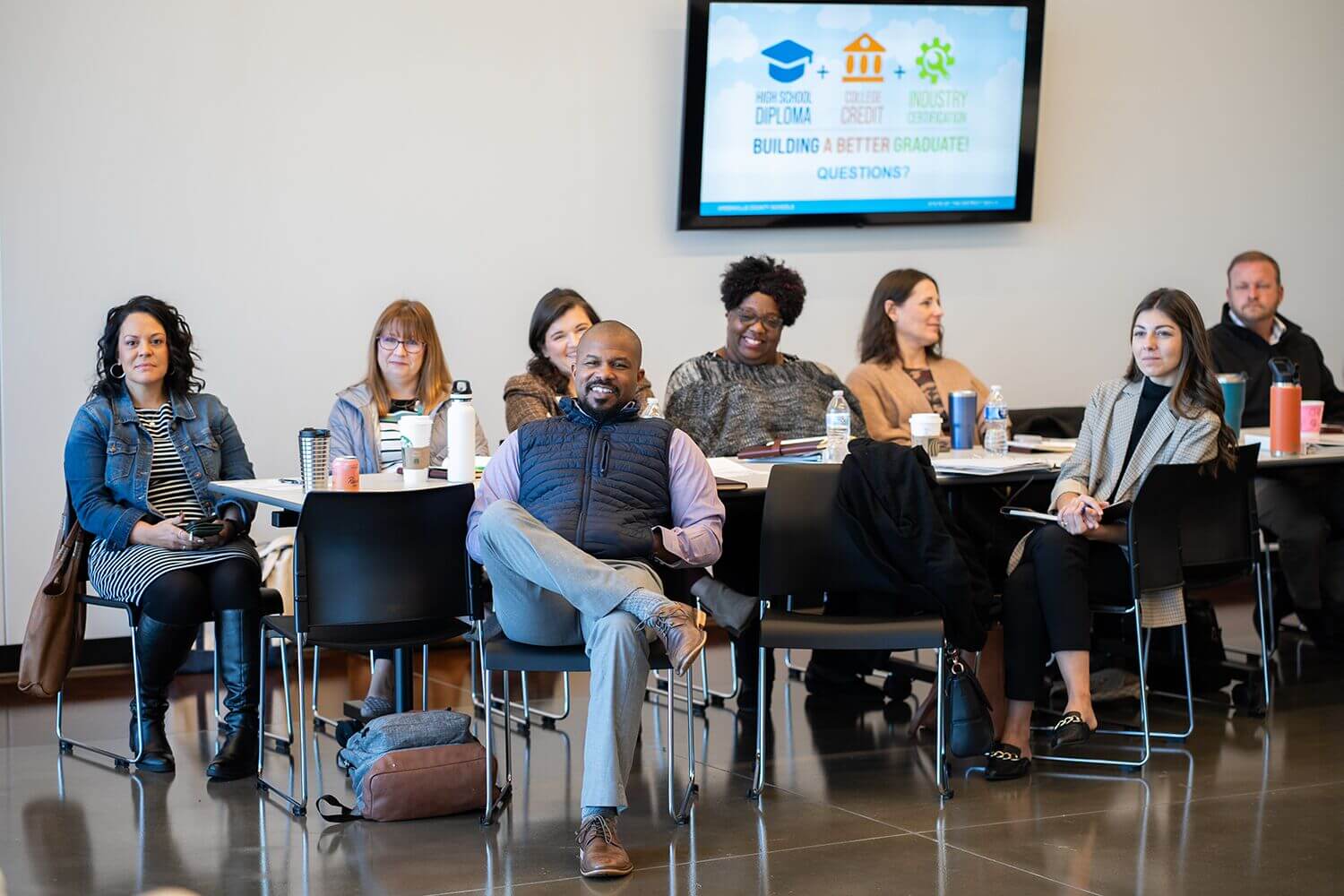 Leadership Greenville members seated in a meeting room facing a presentation screen