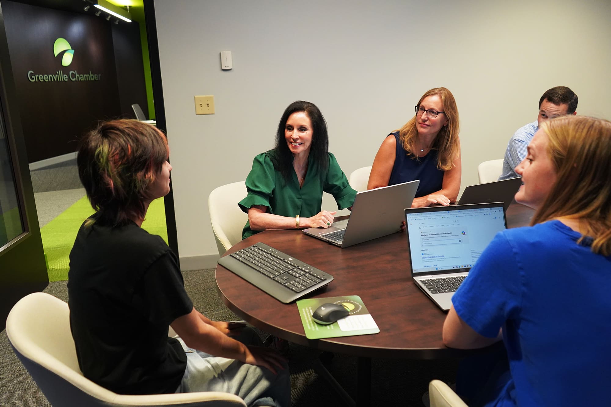 people seated around table talking during meeting