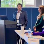 presenter talking with other people getting ready to do presentation
