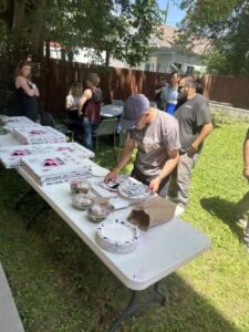 group of people eating pizza and networking