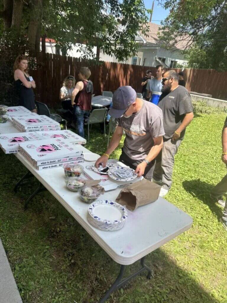 group of people eating pizza and networking