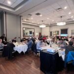 large group of people listening to presentation