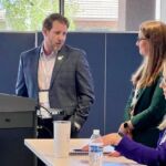 presenter talking with other people getting ready to do presentation