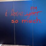 hand written sign that says I love FM so much with you crossed out and FM written above it