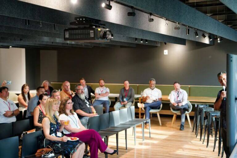 man giving presentation in front of rows of people