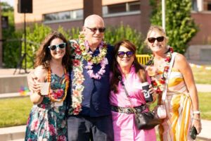 people with leis around necks smiling for camera