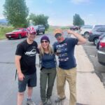 group of people gathering in parking lot to go on hike