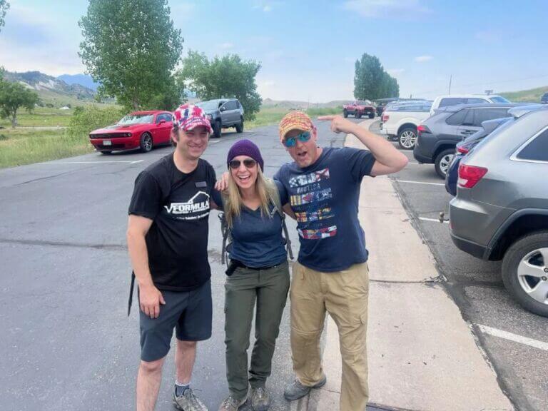 group of people gathering in parking lot to go on hike