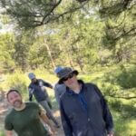four people hiking together