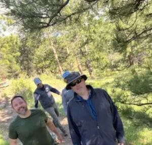 four people hiking together