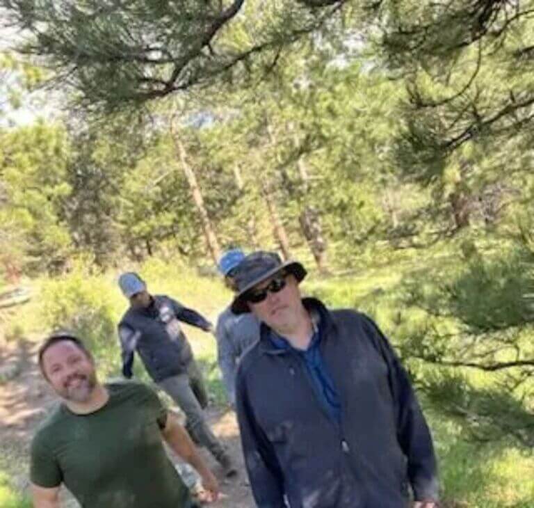 four people hiking together