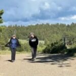 two people hiking on path